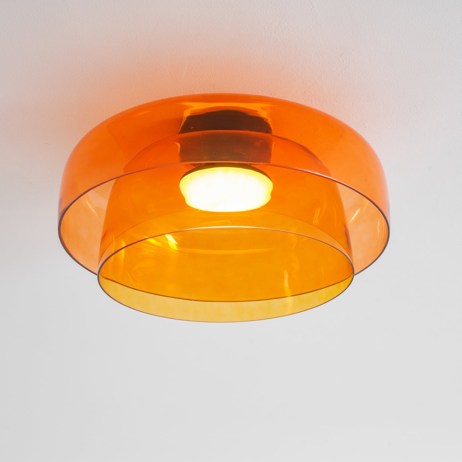 Tinted glass-disc ceiling light mounted flush overhead