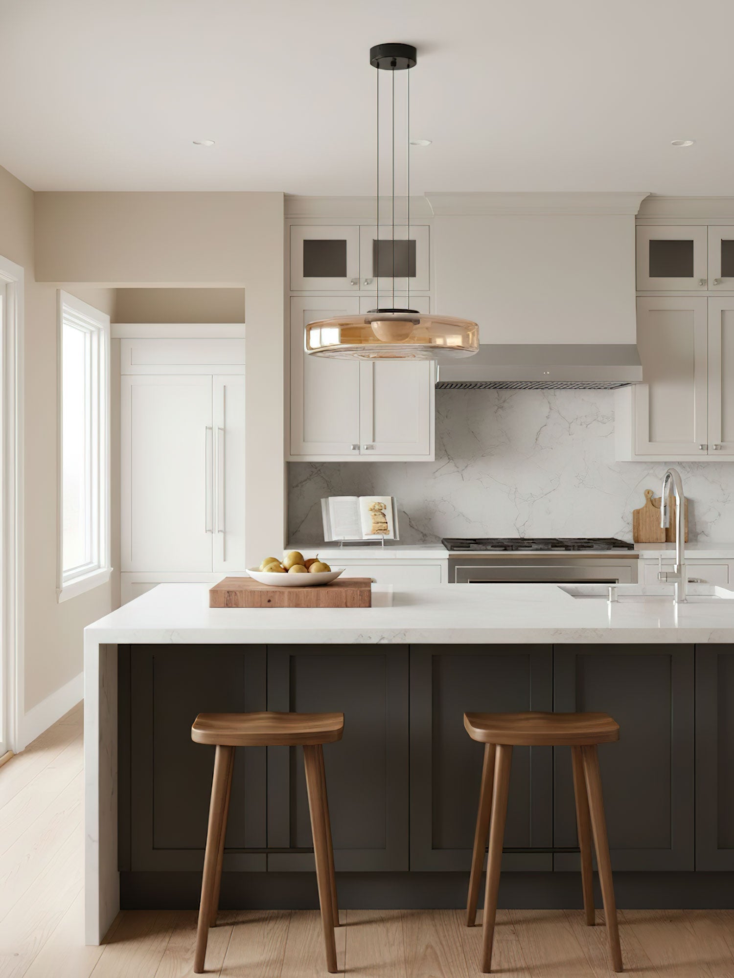 Single-disc glass pendant light glowing warm against a dark wall