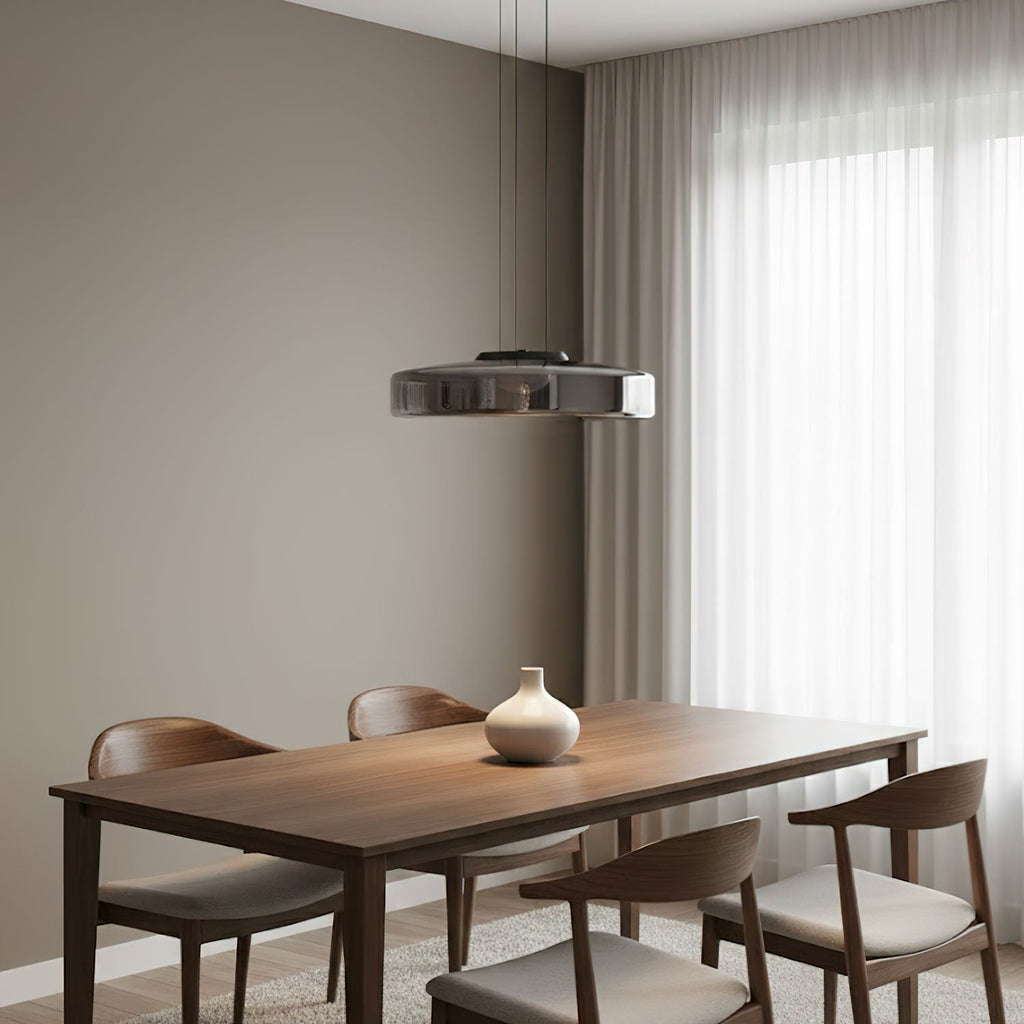 Amber mouth-blown glass pendant light glowing warmly above a room