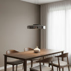 Amber mouth-blown glass pendant light glowing warmly above a room