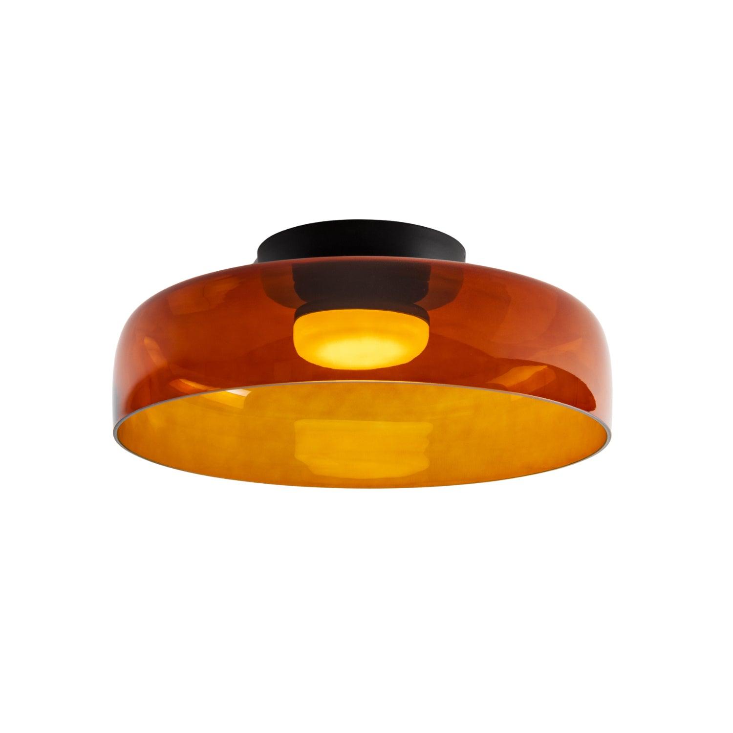 Layered glass ceiling light casting soft light over a kitchen
