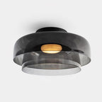 Glass-disc ceiling light mounted flush with a slim profile