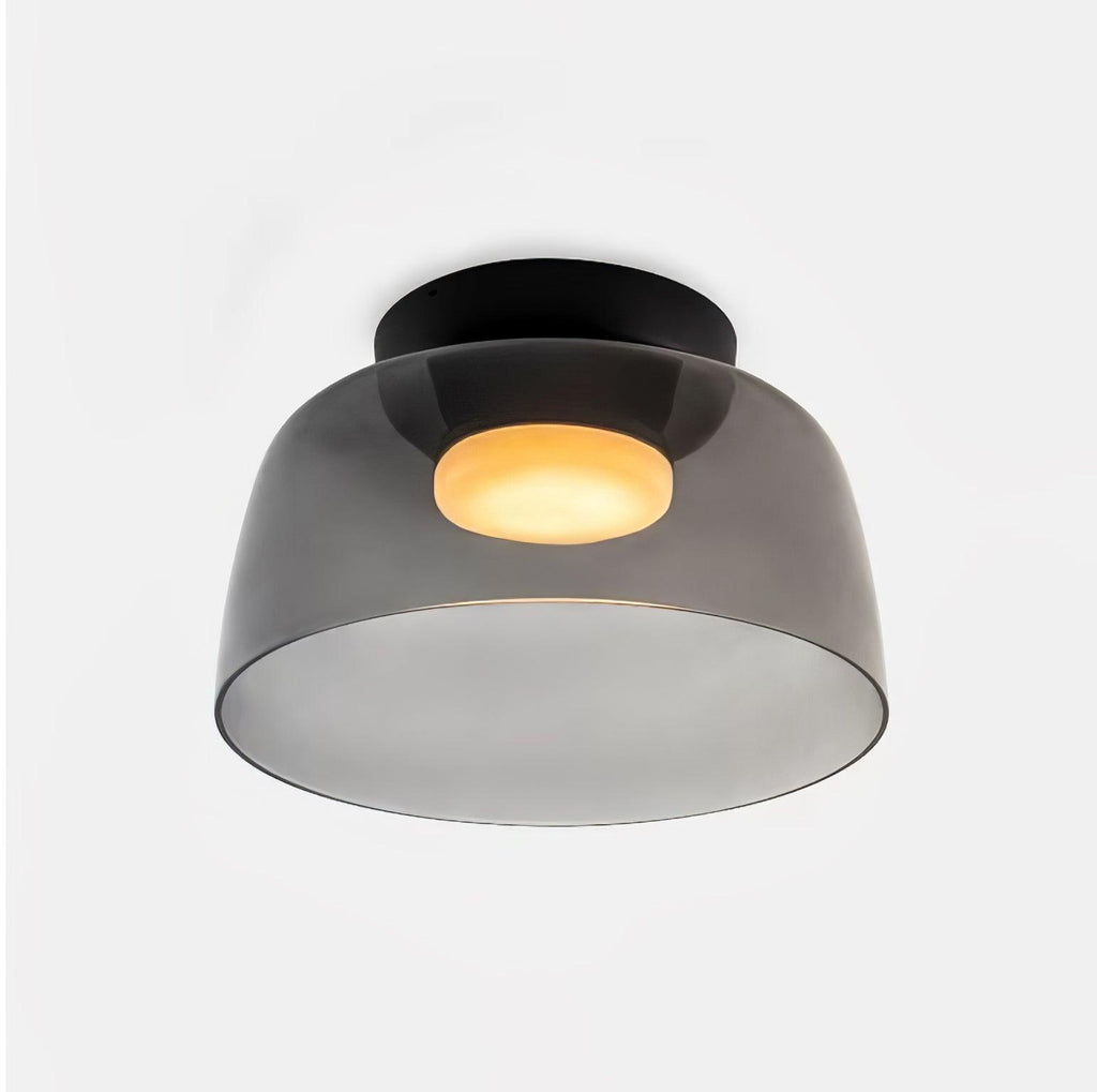 Stacked glass-disc ceiling light glowing soft warm light in a hallway