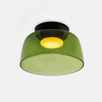 Flush mount glass ceiling light diffusing a balanced even glow