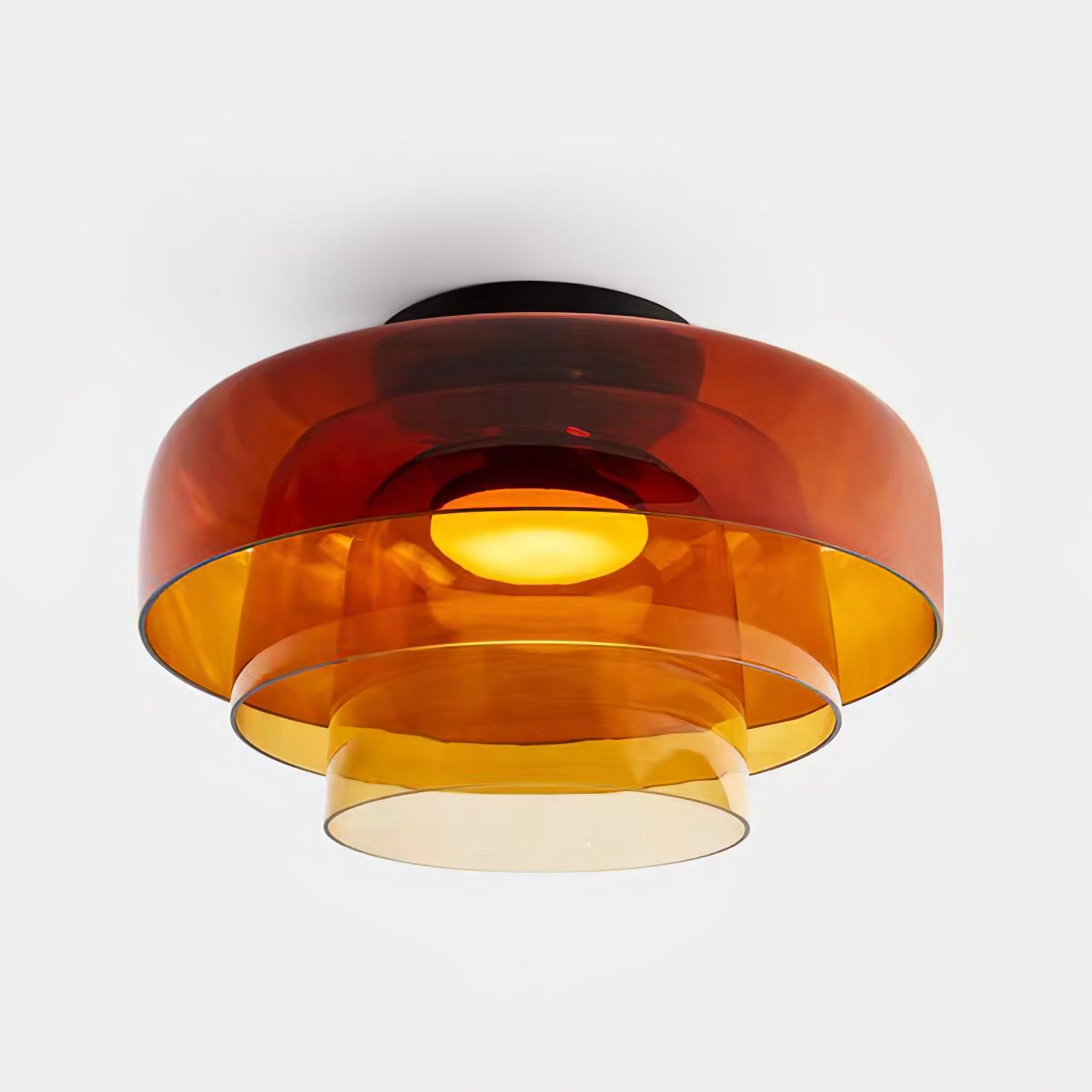 Layered tinted glass ceiling light glowing warm in a bedroom