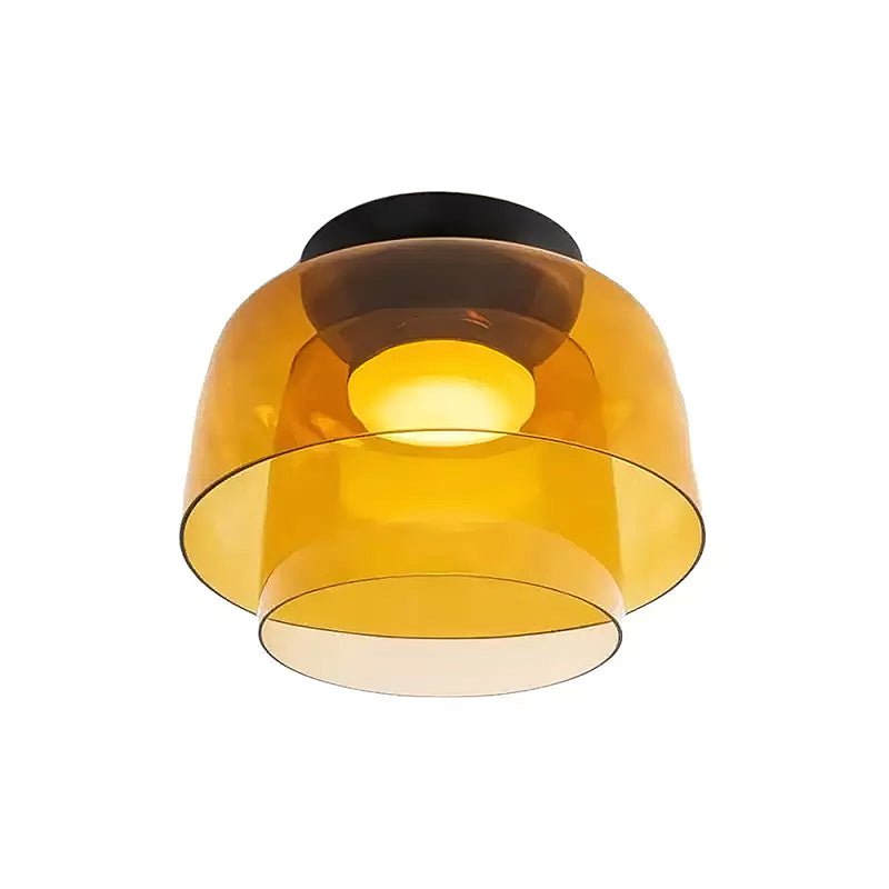 Orange-toned glass ceiling light glowing warm in a styled room