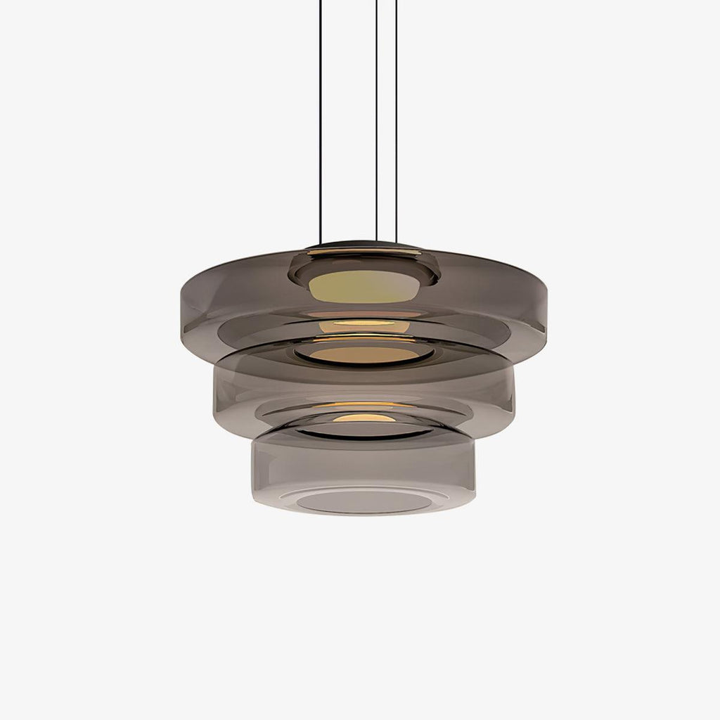 Mouth-blown glass disc pendant light catching warm light from within