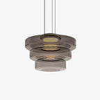 Mouth-blown glass disc pendant light catching warm light from within