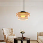 Stacked glass pendant light casting a warm dimensional glow