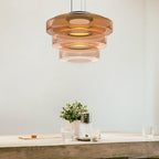 Tinted glass pendant light hanging at adjustable cable height