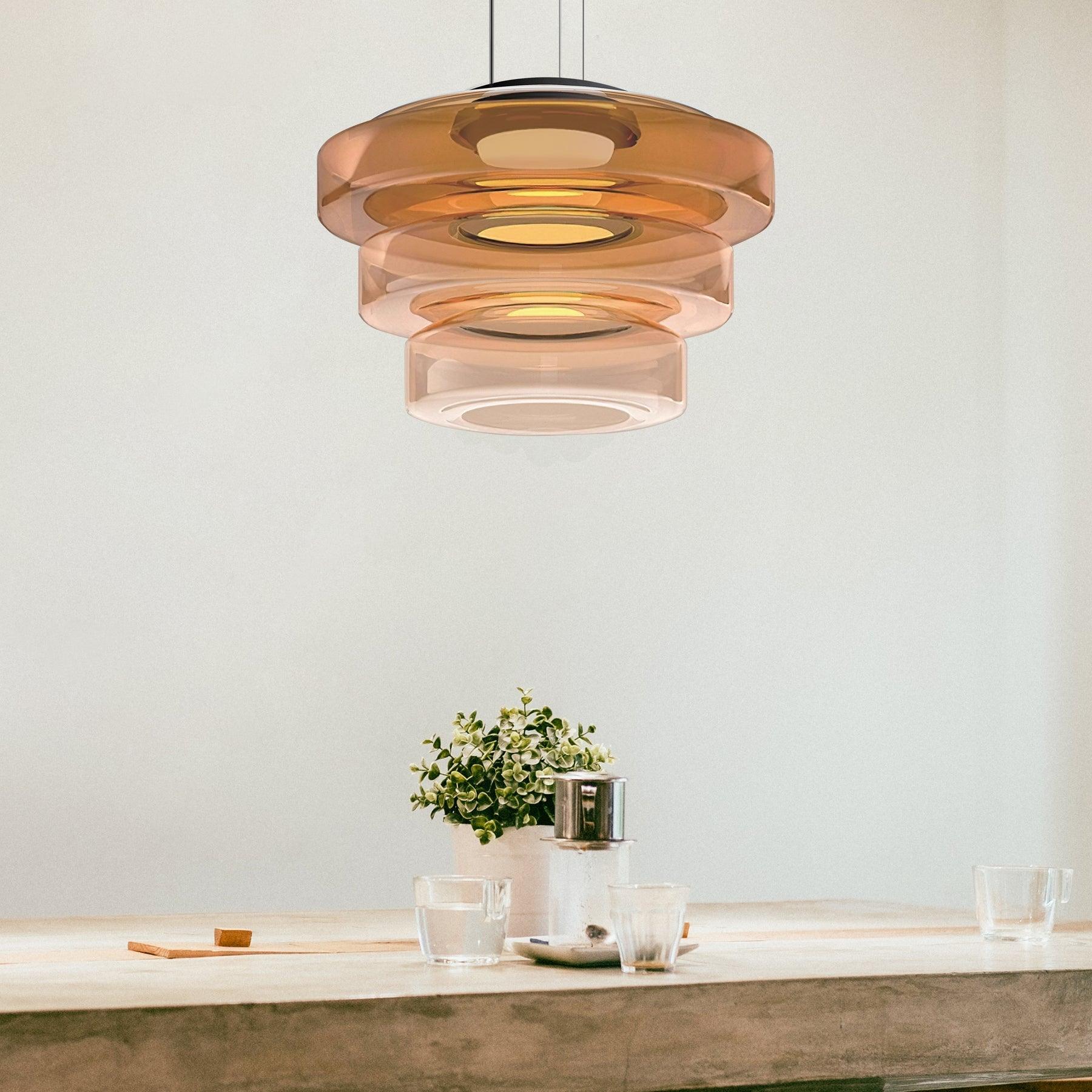 Tinted glass pendant light hanging at adjustable cable height