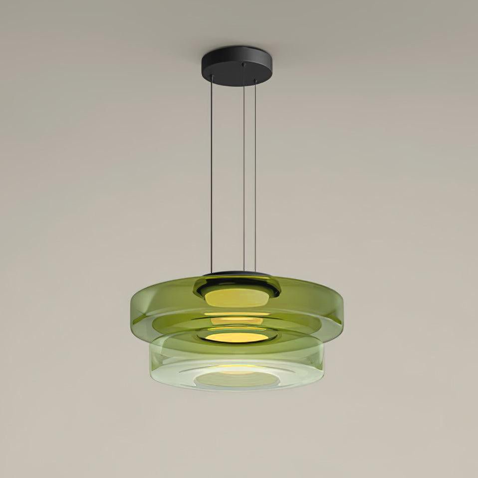 Tinted glass pendant light casting warm dimmable light over a table
