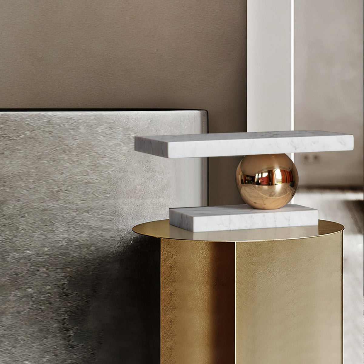 Clérachic white marble table lamp perched on a brushed-gold cylindrical nightstand beside a bed.