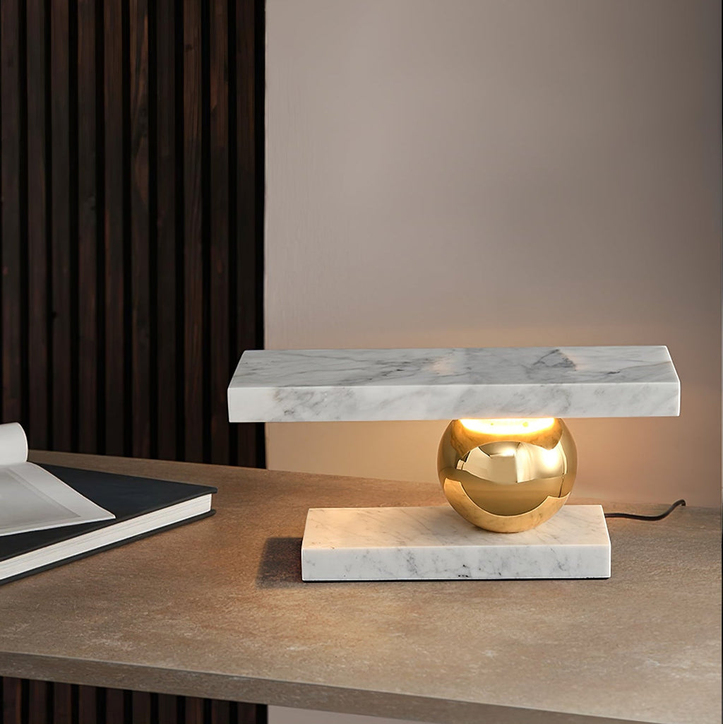 A notebook sits on the wooden desk beside the Clérachic white marble lamp, a wood-slat wall behind it.