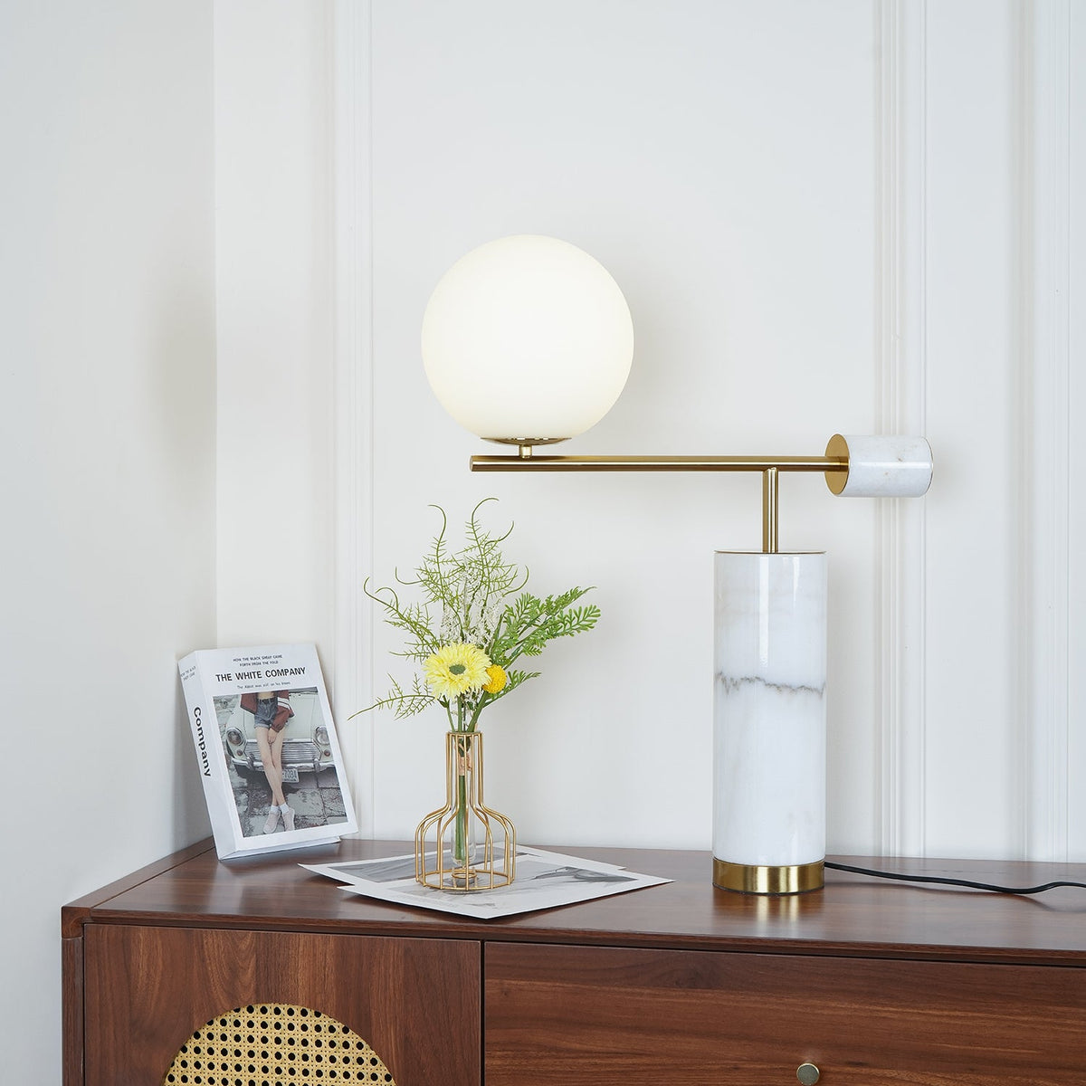 A wider crop of the dresser scene shows the lit Clérachic lamp against the full panelled wall behind it.