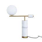 A plain white studio shot of the white marble Clérachic lamp, its power cord coiled loosely on the floor beside it.