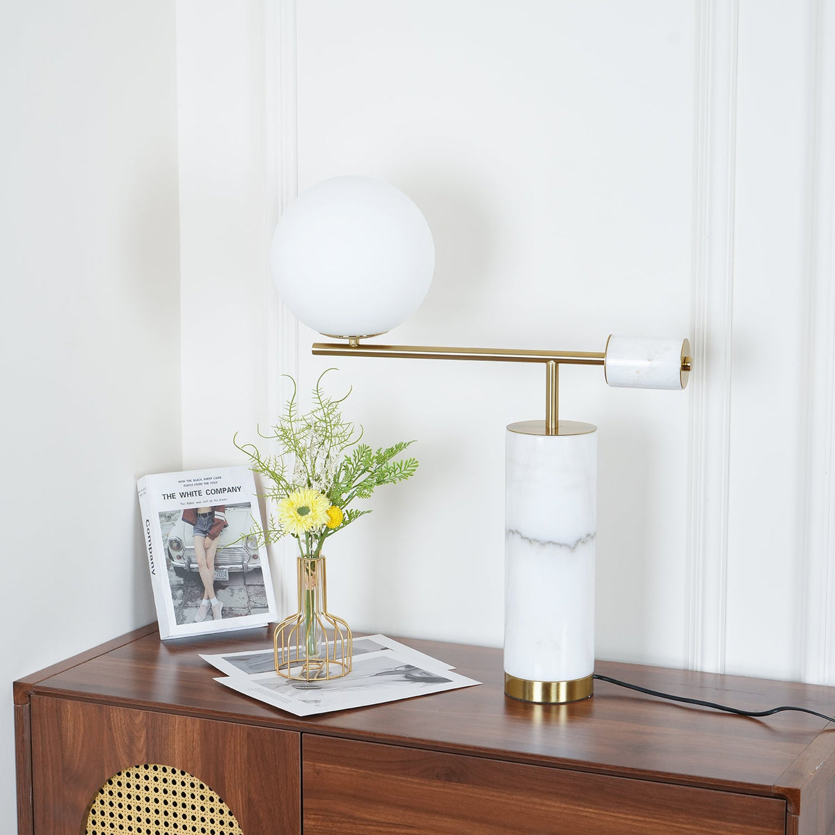 The lit Clérachic lamp returns to its standard dresser framing, globe upper left and brass disc cap edge-on at right.