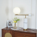 In this dresser scene, the Clérachic lamp's globe sits higher in frame while its brass disc turns at a slight angle.