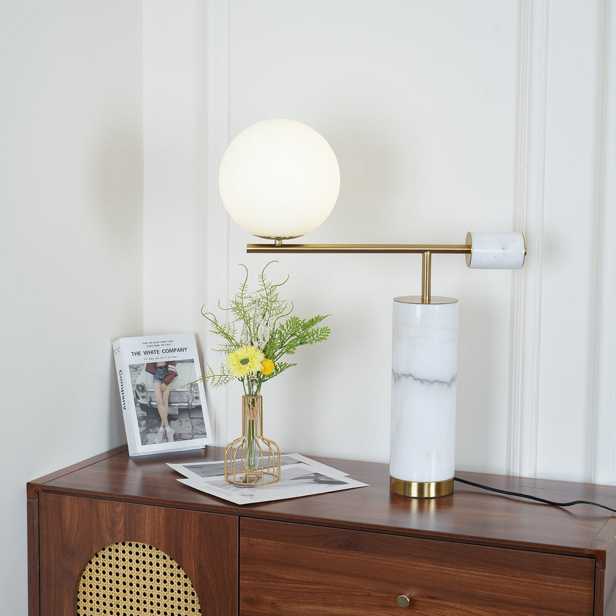 In this dresser scene, the Clérachic lamp's globe sits higher in frame while its brass disc turns at a slight angle.