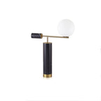 Set further from the camera, the Clérachic gold table lamp appears smaller within a plain white studio frame.