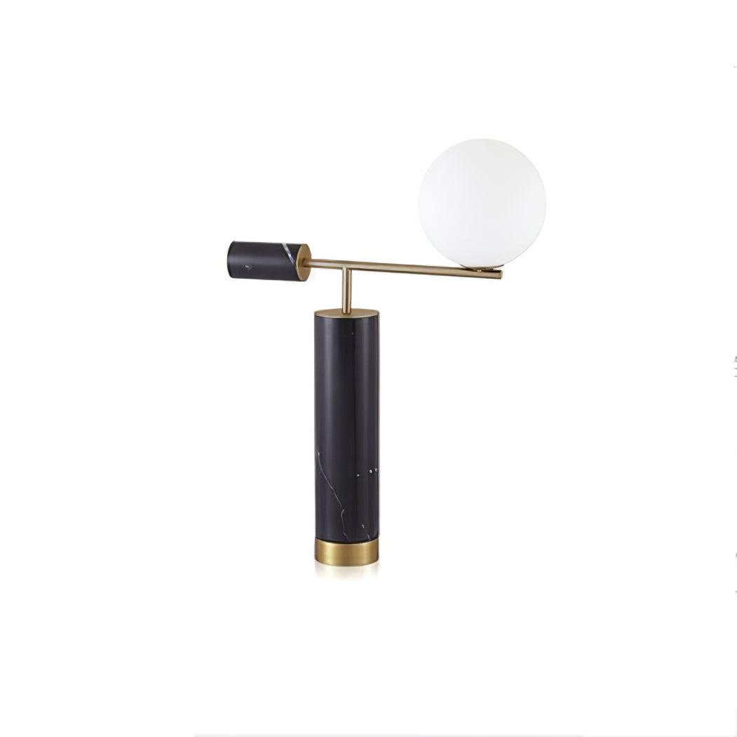 Set further from the camera, the Clérachic gold table lamp appears smaller within a plain white studio frame.
