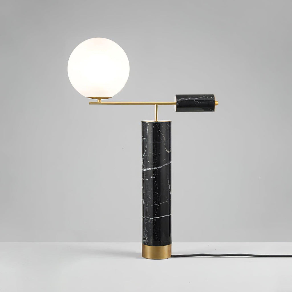This Clérachic table lamp sits on a grey studio backdrop, its power cord trailing visibly from the black marble base.