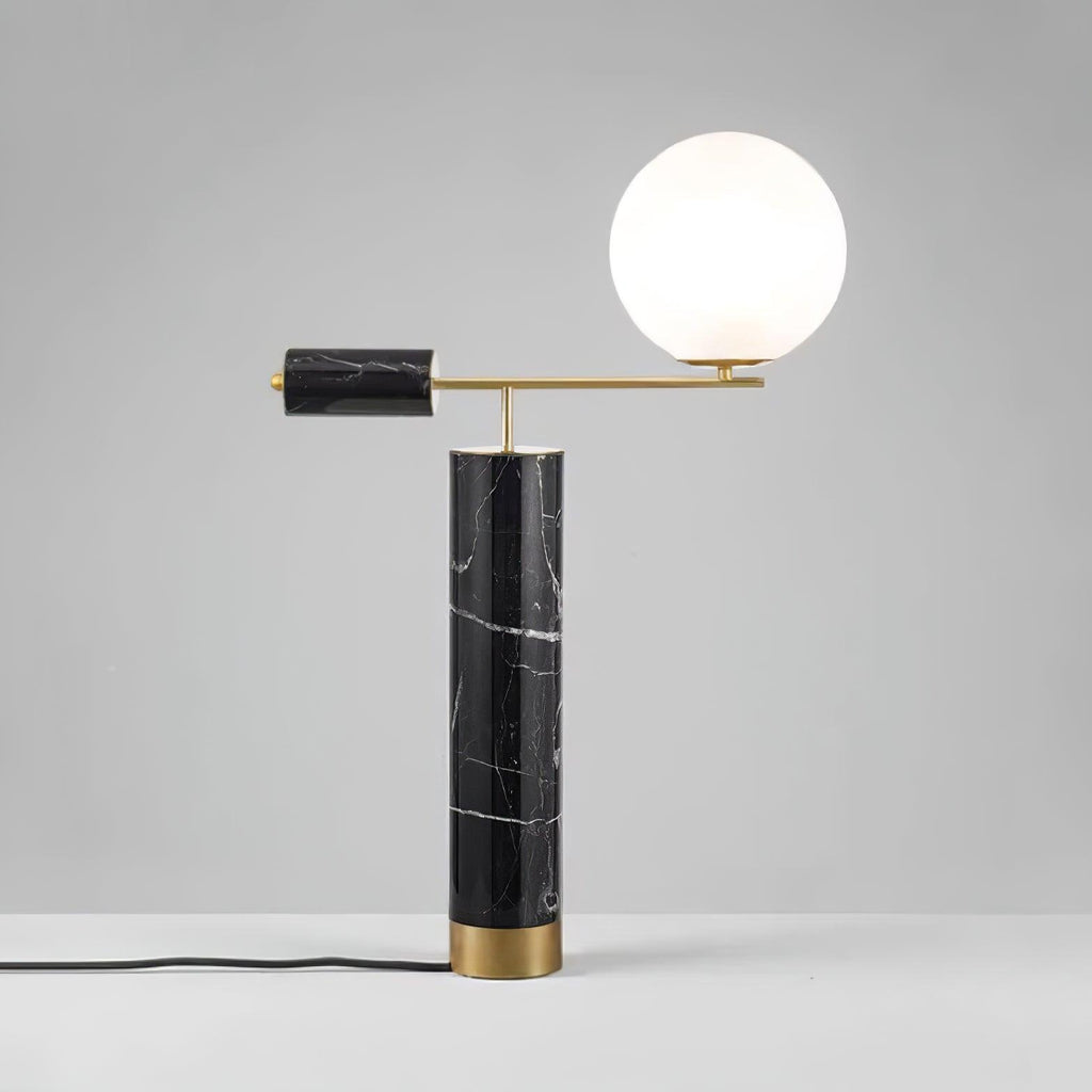 Photographed full-length on a grey backdrop, the Clérachic lamp's power cord curls visibly beside its black marble base.