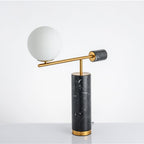 Shot at a steep angle against a grey backdrop, the Clérachic lamp's arm and globe tilt diagonally across the frame.