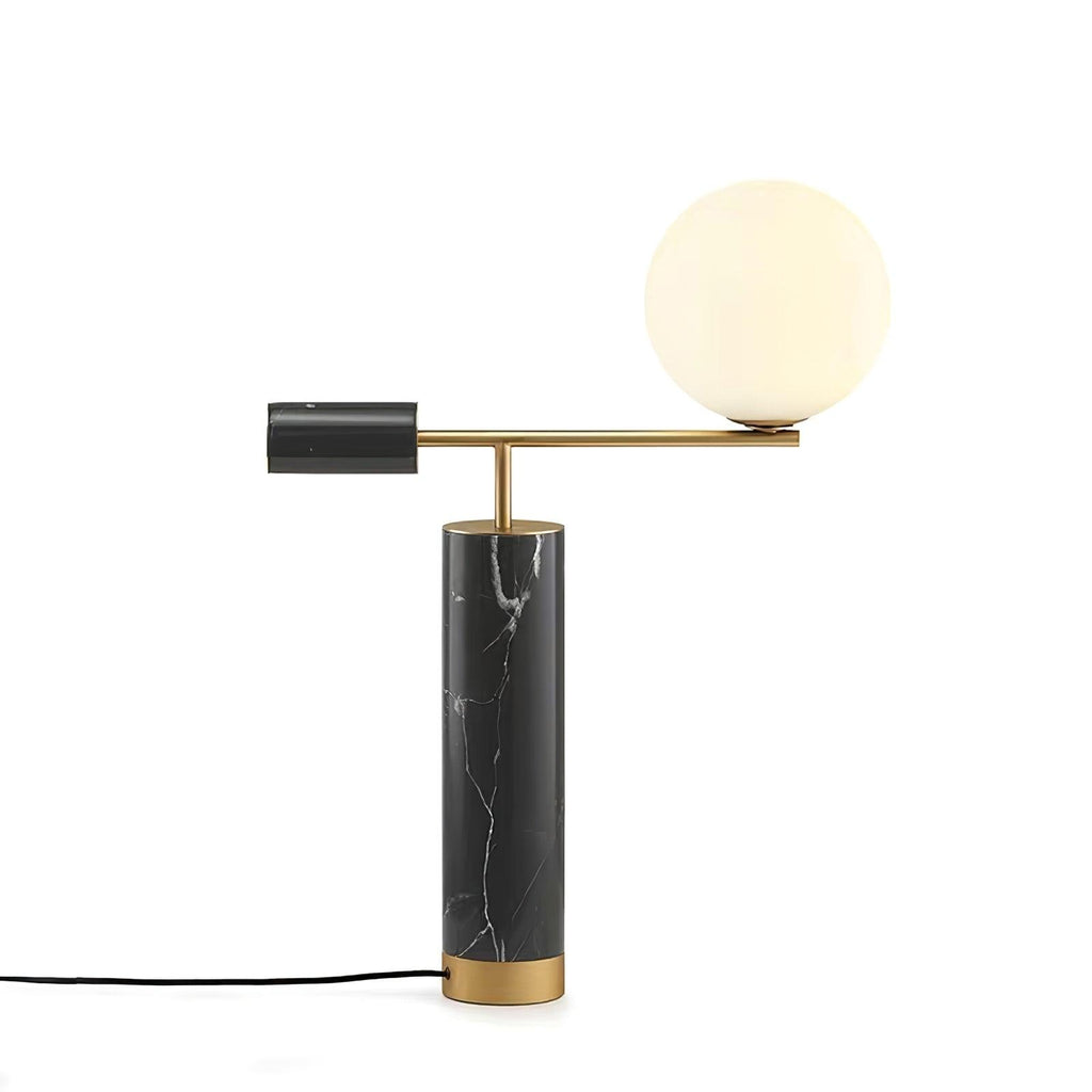 Photographed against grey, the Clérachic lamp's power cord curls at its base, the black marble column sharply lit.