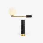 Another plain-background shot of the Clérachic lamp, its black marble base catching a faint reflection below.