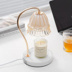 With books and a laptop close by, this Clérachic candle warmer lamp stands on a desk beside a glass of iced drink.