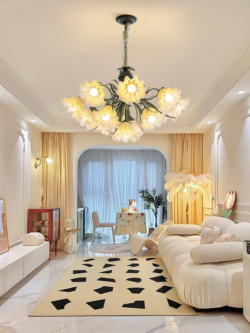 Through a hallway arch over a black and white patterned rug, this Clérachic chandelier lights the space.