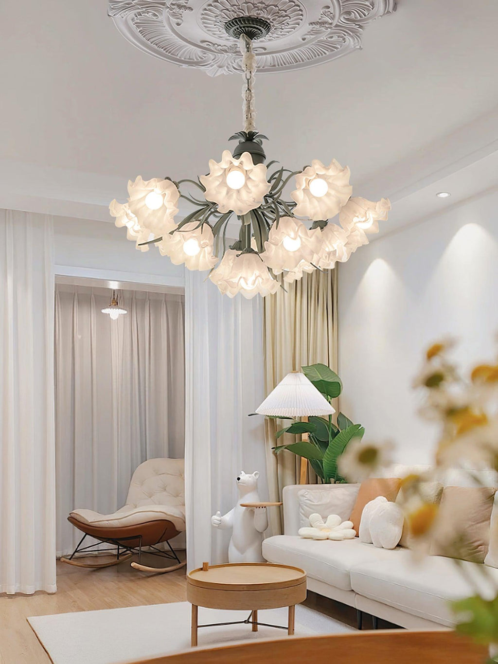 Seen through an open-plan living space, this Clérachic chandelier lights the room from a high ceiling.