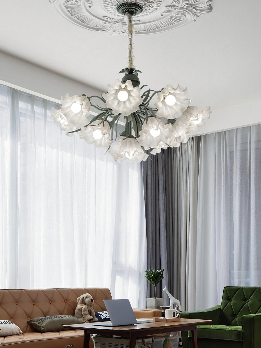 Above a sofa where a dog rests beside a laptop, this Clérachic chandelier lights the living room.