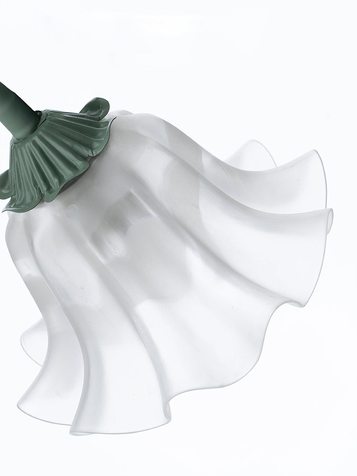 Close view of an unlit shade on this Clérachic chandelier, showing its fluted white petals and green fitting.