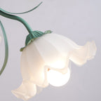 Close view of a single lit flower shade on this Clérachic chandelier, its green stem and leaf detail visible above.