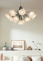Above a pale sofa and framed print, this Clérachic chandelier glows warm in a bright living room.