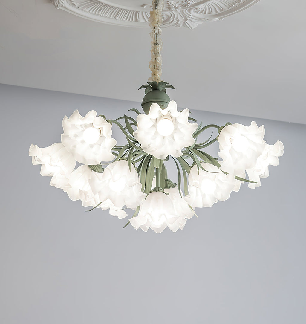 Against a grey backdrop, this Clérachic chandelier's green stems arch out beneath its unlit white shades.