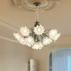Seen from below against a carved ceiling medallion, this Clérachic chandelier's shades glow warm gold.