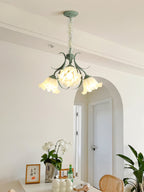 Through a hallway arch past an orchid on a side table, this Clérachic chandelier lights the space.