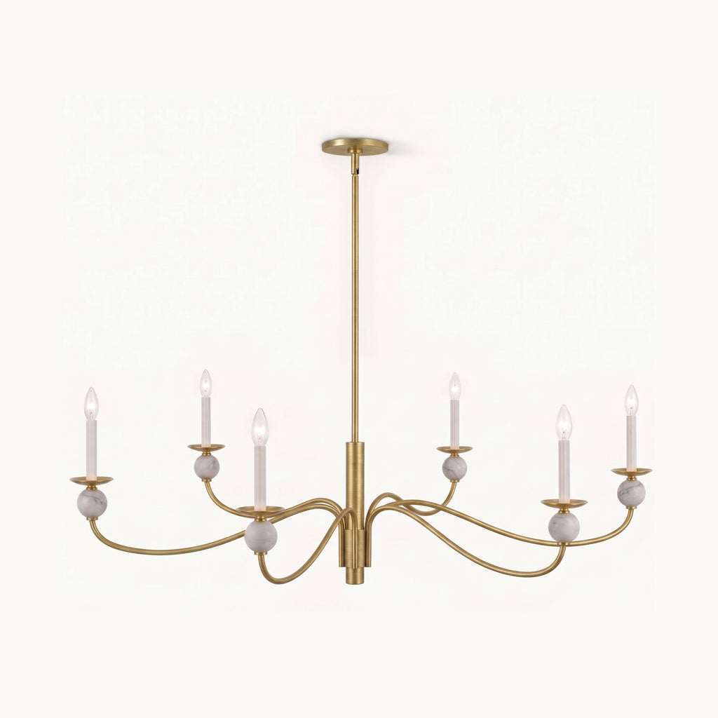 Angled on a plain backdrop, this Clérachic chandelier's brushed brass wave arms and stone ball accents catch the light, unlit.