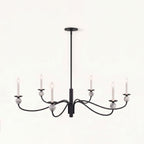 Front-facing on a plain backdrop, this Clérachic chandelier's matte black wave arms and stone ball accents stand out, unlit.