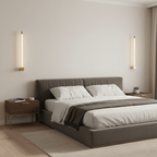 Black vertical LED wall sconce casting a clean line of light