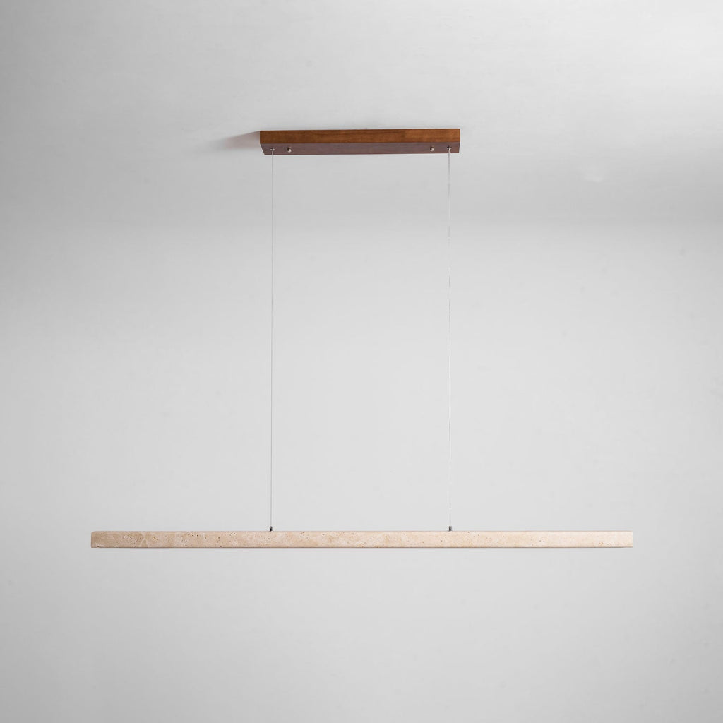 This Clérachic pendant's dark wood canopy and travertine bar are shown unlit against a soft grey backdrop.