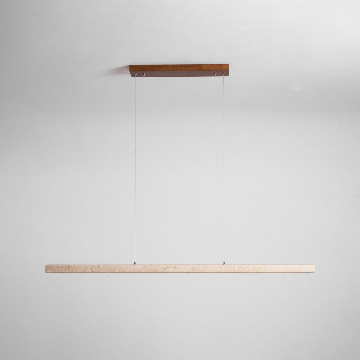This Clérachic pendant's dark wood canopy and travertine bar are shown unlit against a soft grey backdrop.