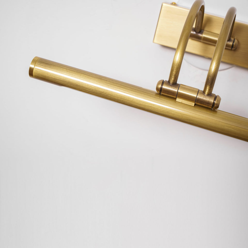 Cylindrical dark bronze vanity bar with white acrylic shade