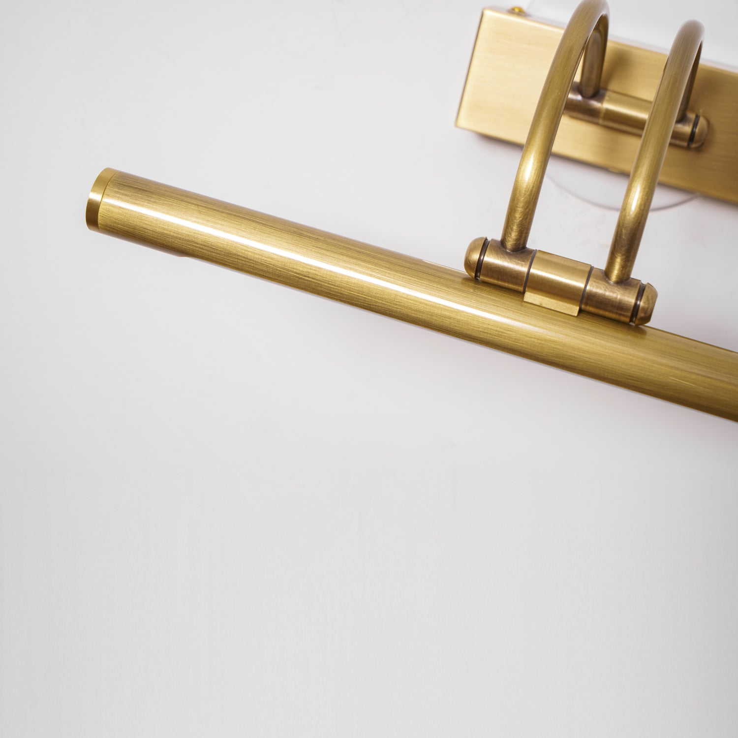 Cylindrical dark bronze vanity bar with white acrylic shade