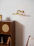Linear vanity wall light with brass accents on a neutral wall