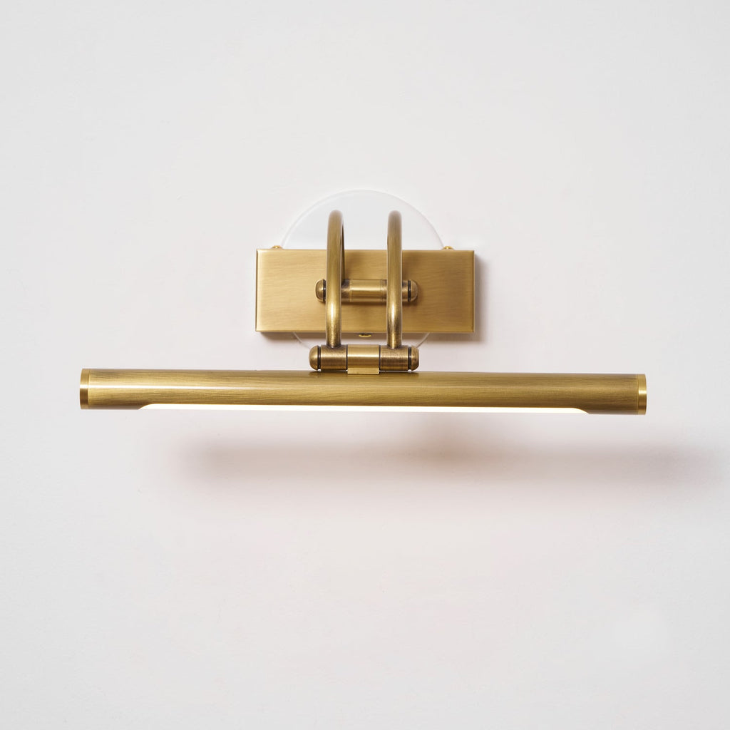 Dark bronze vanity wall light with brass accents and even glow
