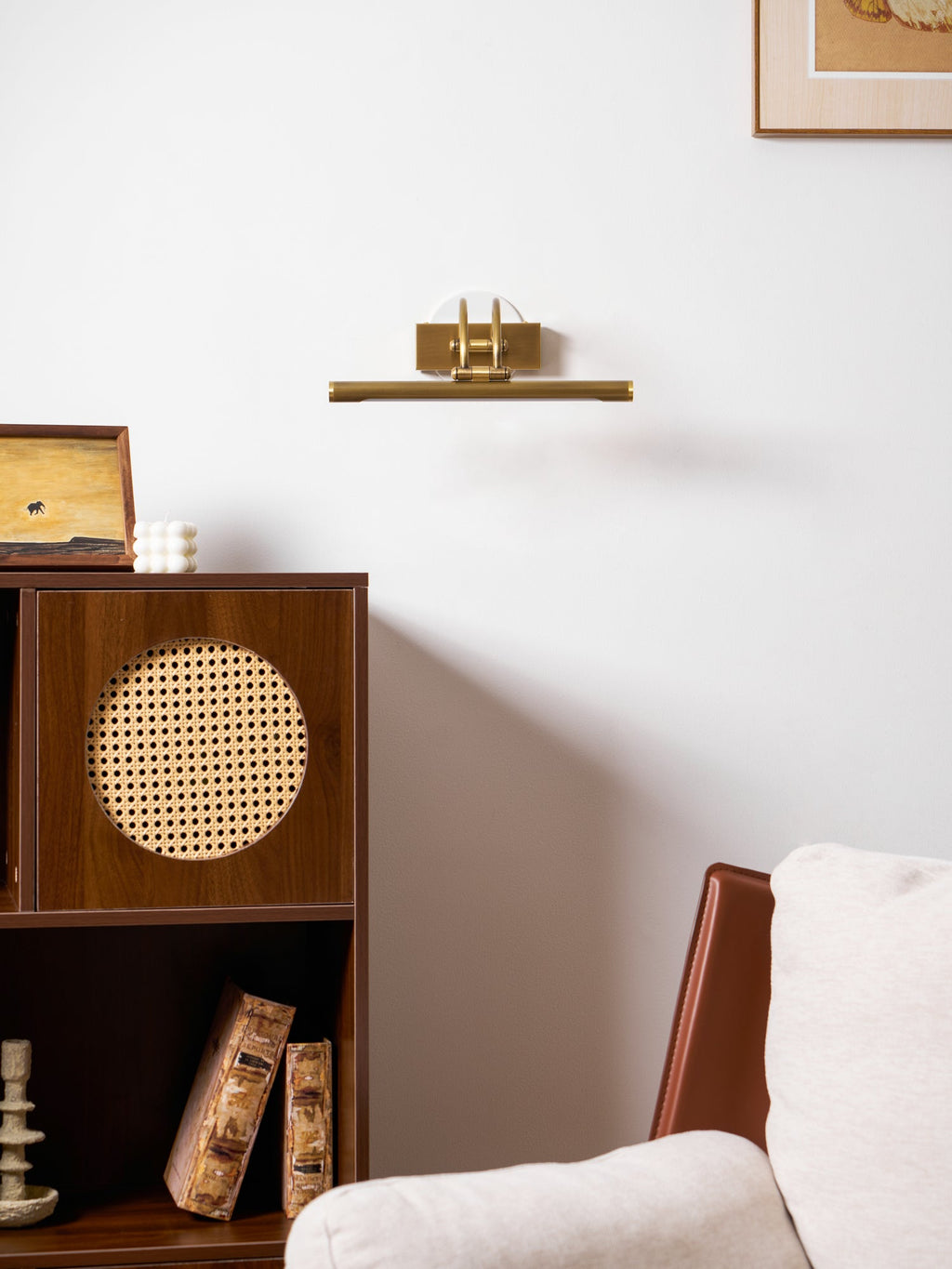 Slim vanity wall light shown with brushed brass detailing